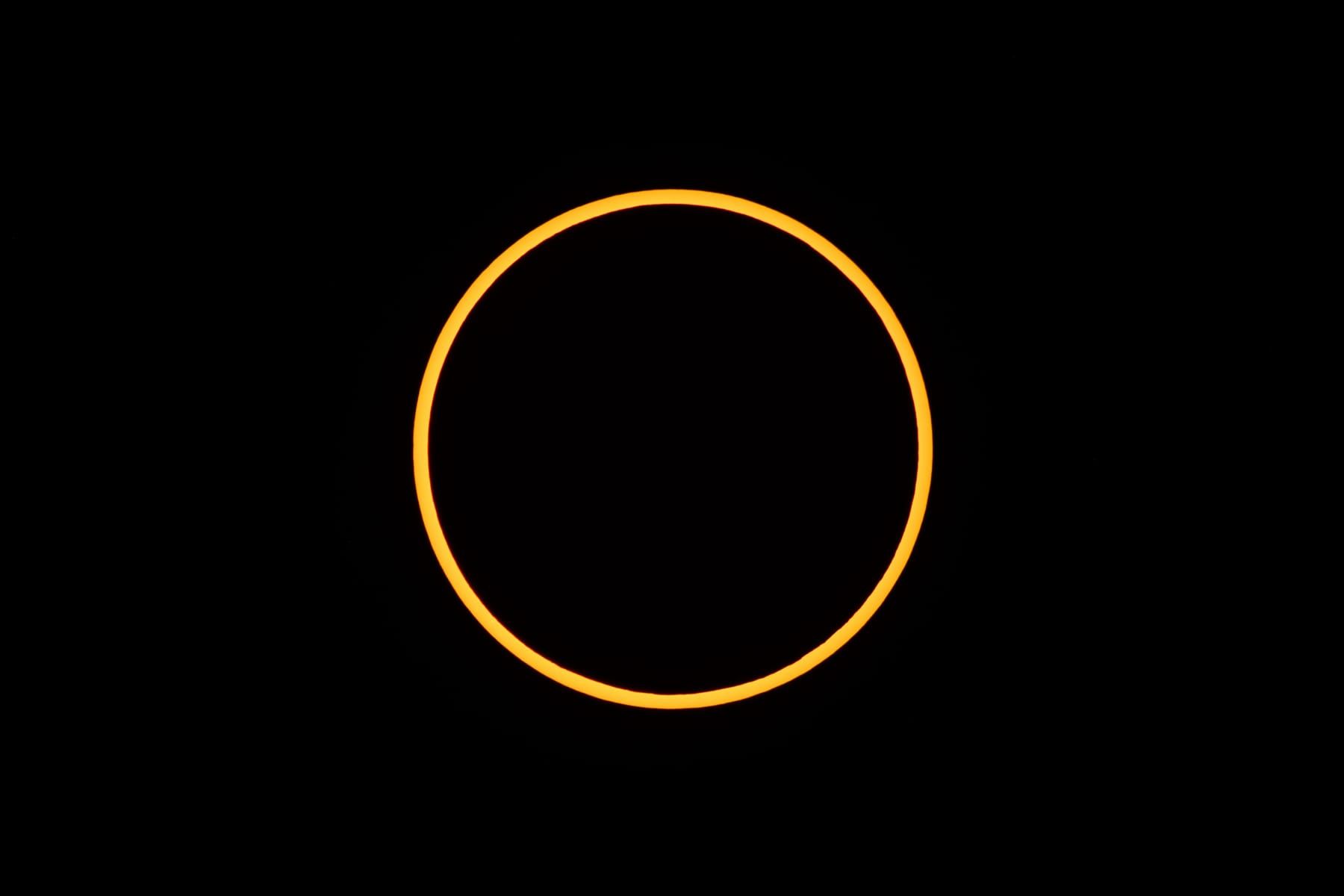 A bright ring of sunlight around the dark disc of the Moon during an annular solar eclipse
