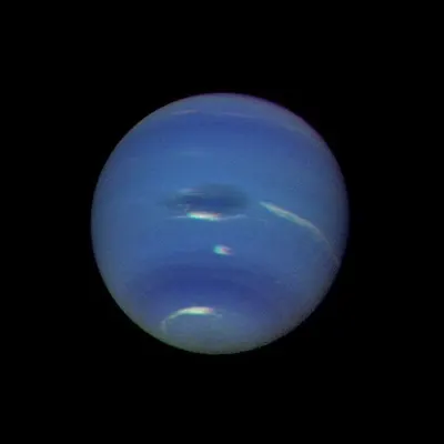 Neptune's blue-green atmosphere is shown in greater detail than ever before by NASA's Voyager 2 spacecraft as it rapidly approaches its encounter with the giant planet. This color image shows several complex and puzzling atmospheric features.