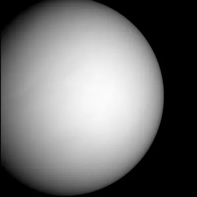 Venus appears like a gray orb against the darkness of space.