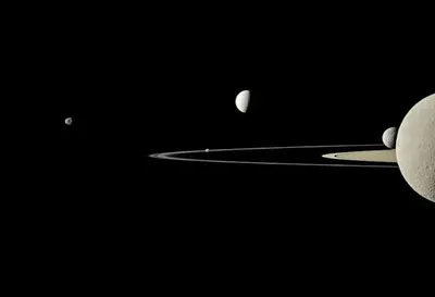 This image from NASA's Cassini spacecraft captured five of Saturn's moons. Moons visible in this view: Janus; Pandora; Enceladus, Mimas & Saturn's second largest moon, Rhea.