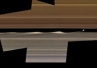 NASA's Cassini spacecraft shows this enhanced-color image mosaic of Daphnis, one of the moons embedded in Saturn's rings.